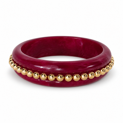 Burgundy rounded bangle with row of gold-tone beads