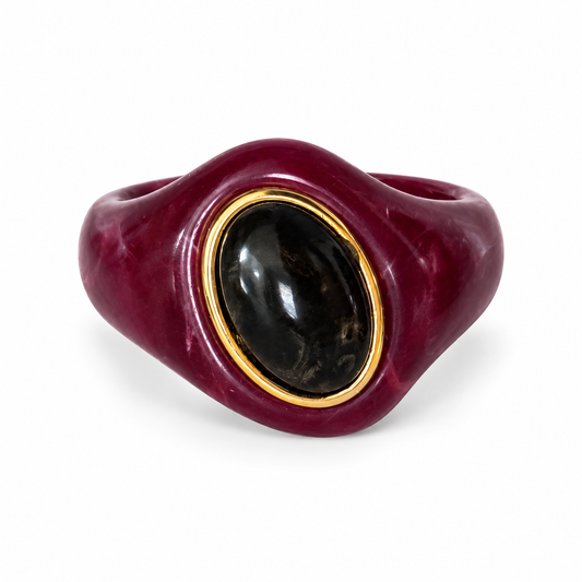 Burgundy marbled statement bracelet with glossy black oval accent and gold-tone trim