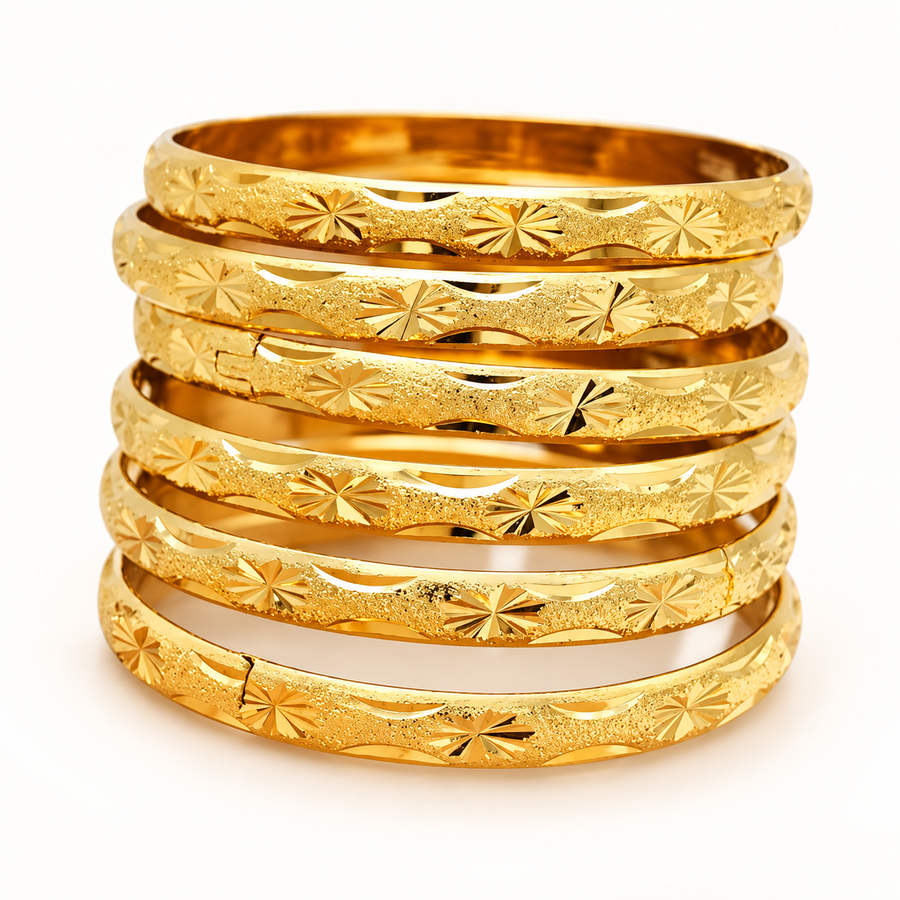 Six matching 18K gold-plated engraved starburst bangles on a white background